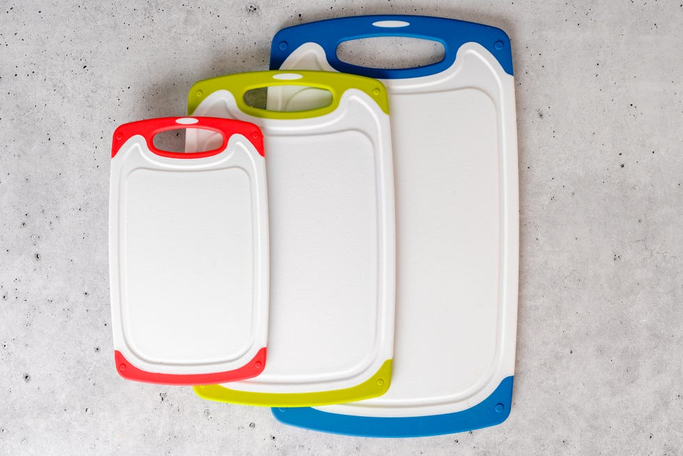 Set of plastic cutting boards in different colors and sizes. Close-up from above with copy space