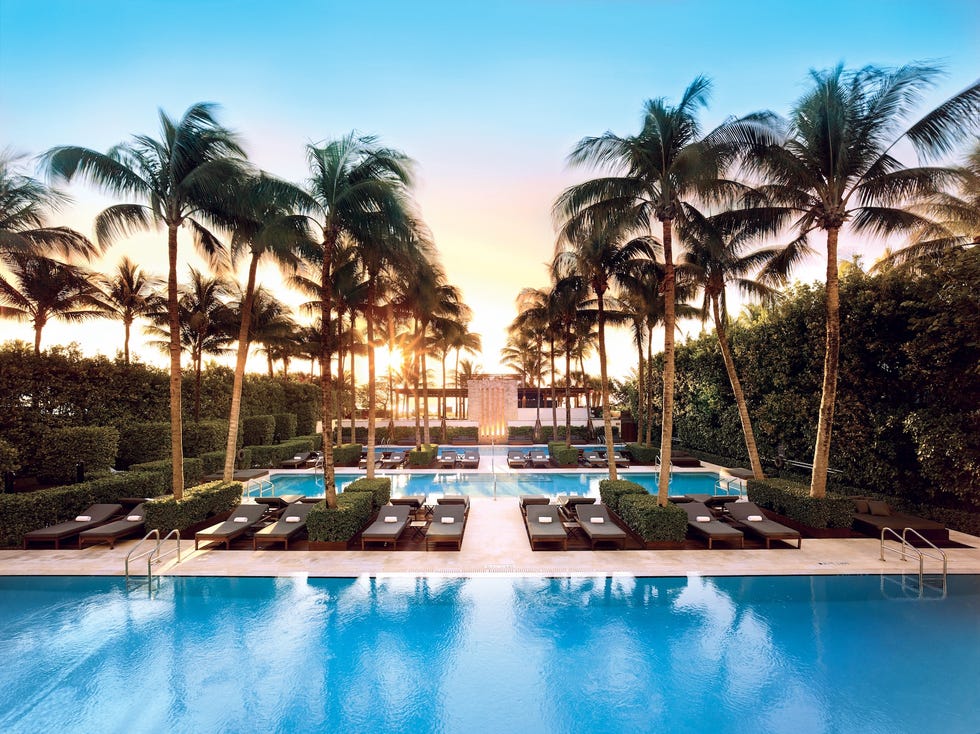 the palm tree lined pool at the setai