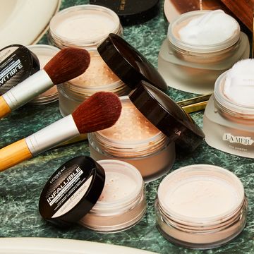 setting powders on bathroom counter with makeup brush