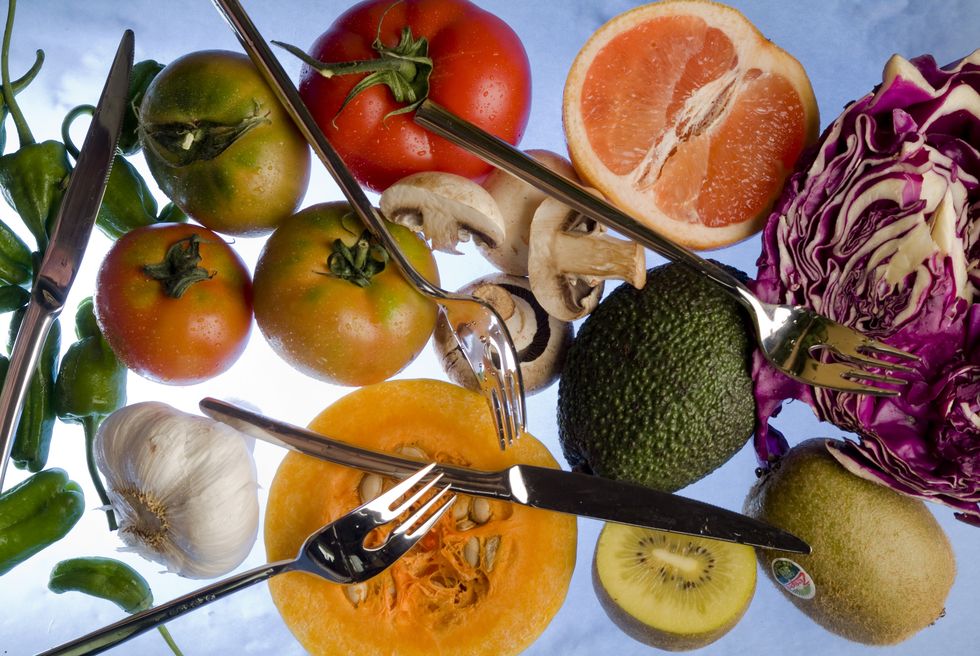 several vegetables and fruits grapefruit, cabbage, peppers, tomatoes, avocados, squash, garlic mushrooms and kiwis