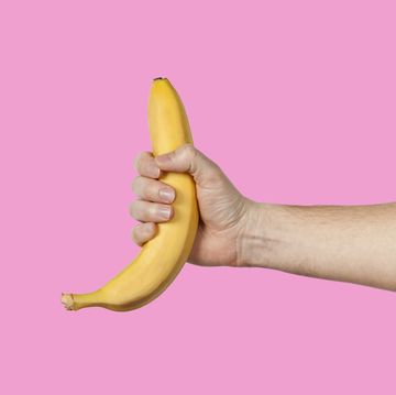 banana as a symbol of male penis in hand on a yellow background hidden by censorship sexual masturbation and orgasm, impotence problem self pleasure concept