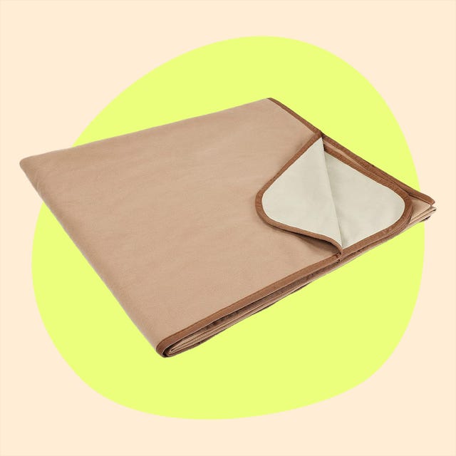 a beige mat folded on the left and a maroon teardropshaped item on the right a beige mat folded on the left and a maroon teardropshaped item on the right