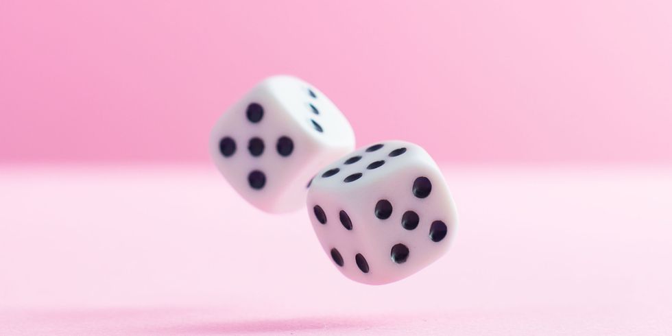 dice against a pink background