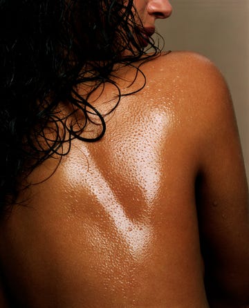 close up of a woman's back covered with massage oil