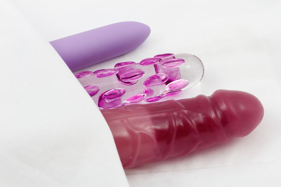 sex toys   glass dildo and vibrators in bed