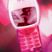 couple touching tongues on screen on a flip phone
