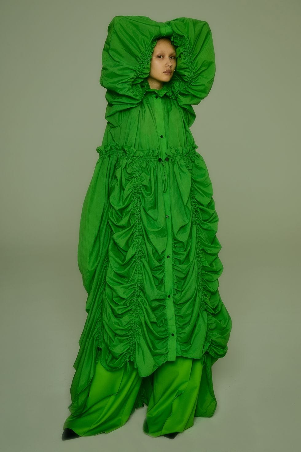 a person in a green garment a person in a green garment