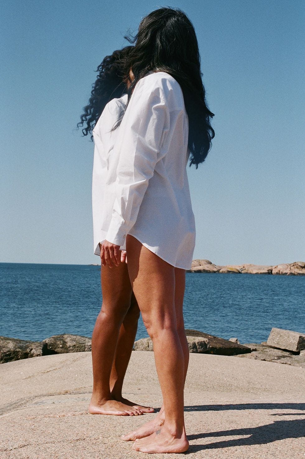 a person standing on a beach a person standing on a beach