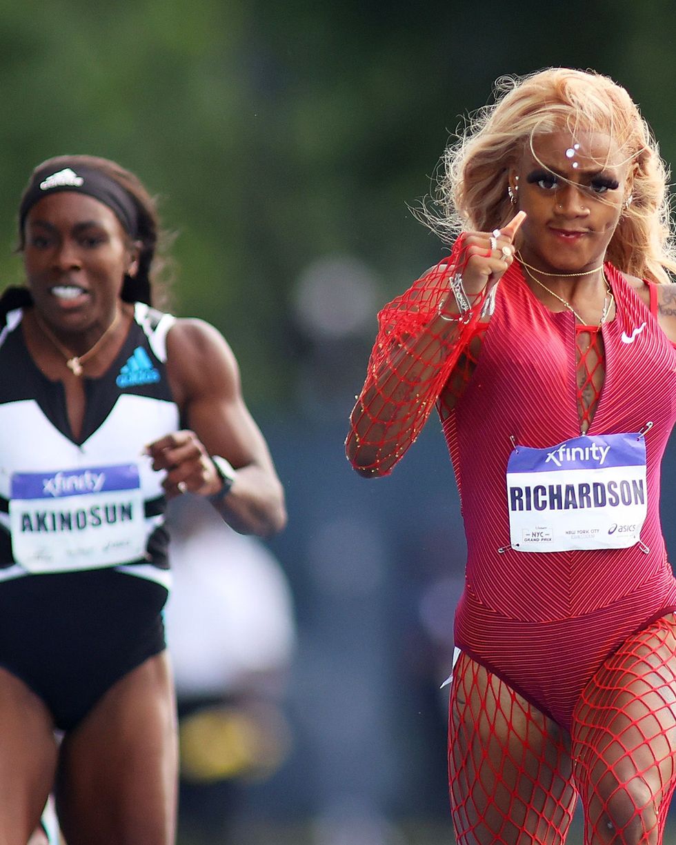 women running in a race while wearing a pink leotard and a red fishnet body suit