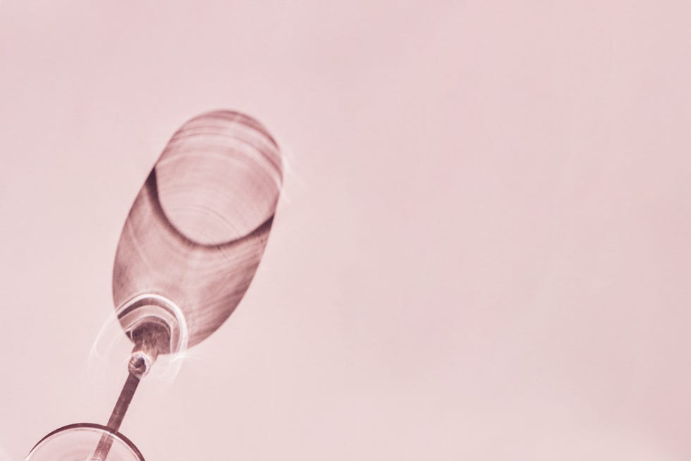 shadow from wine glass on pink background
