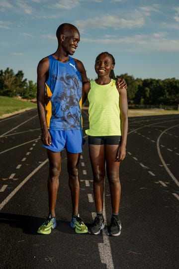 a man and woman standing on a track