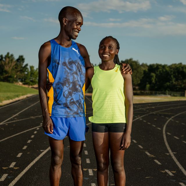 a man and woman standing on a track
