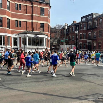 group of runners participating in an outdoor race on a city street group of runners participating in an outdoor race on a city street