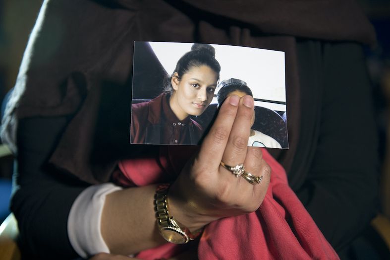 a photograph of shamima begum held by her sister
