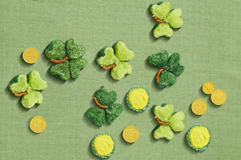 green shamrock shaped cupcakes on a green background