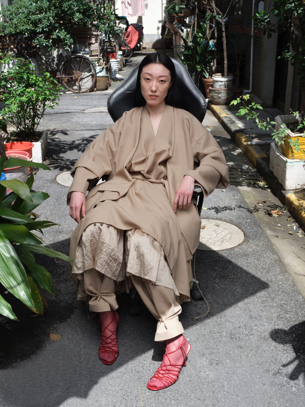 a model sits in an alley