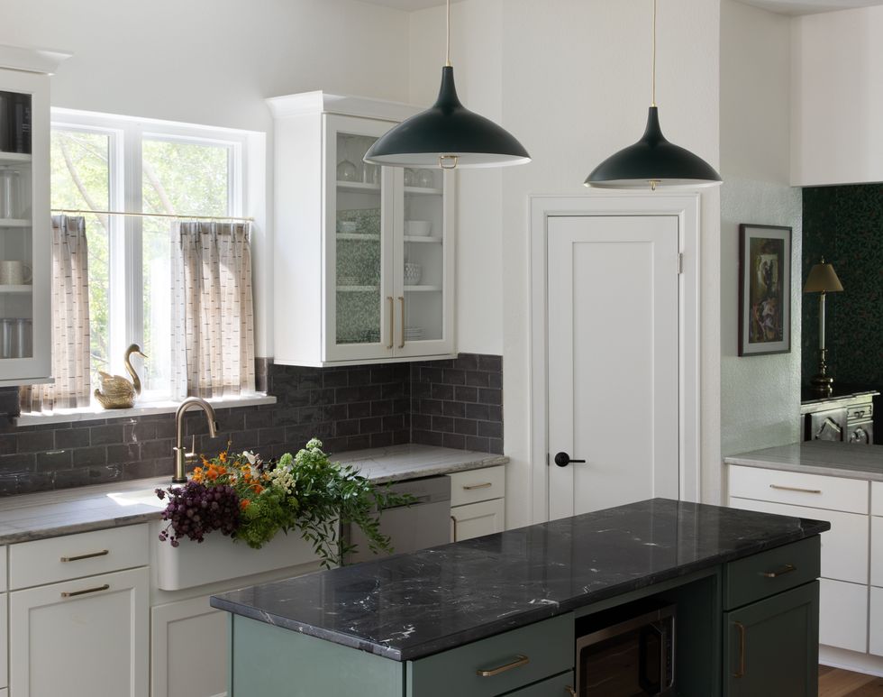 kitchen with black pendant lights and black granite countertops