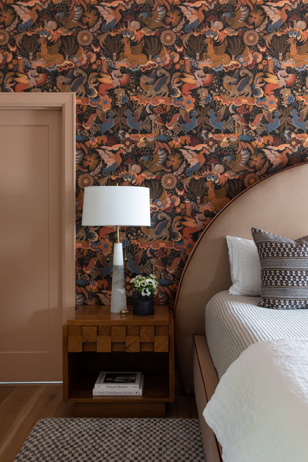 wooden nightstand and bird wallpaper in primary bedroom