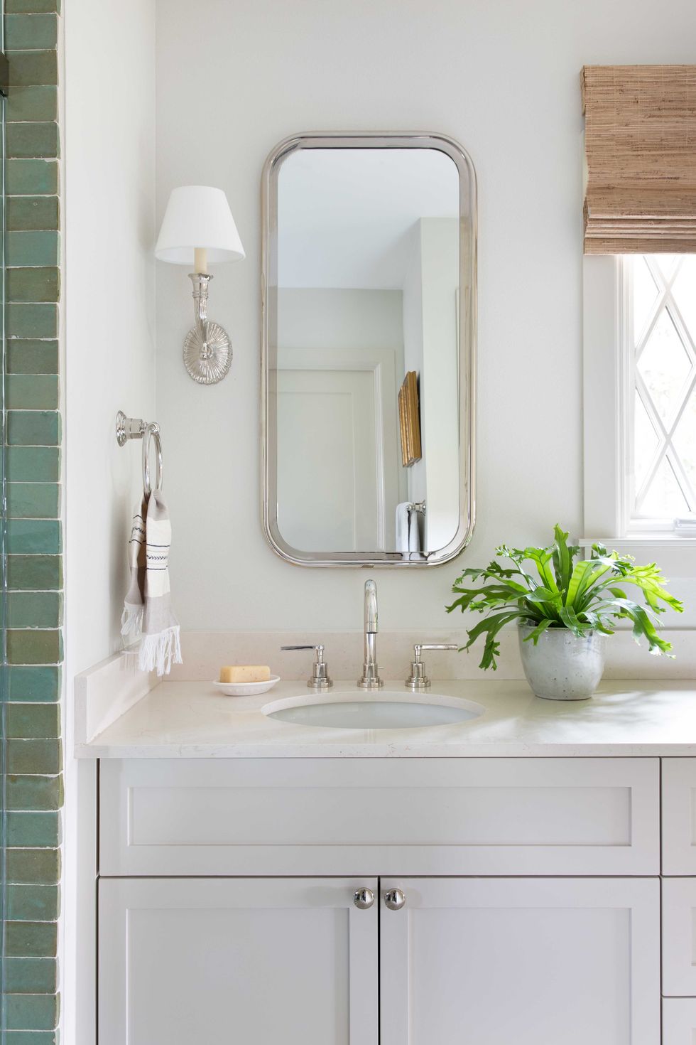 vanity basin, white cabinets, green tiles, white countertop, silver faucets