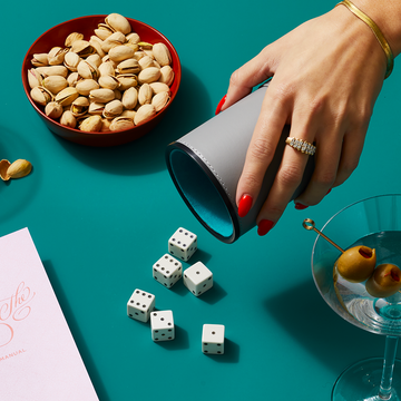 woman with red nails shaking dice woman with red nails shaking dice