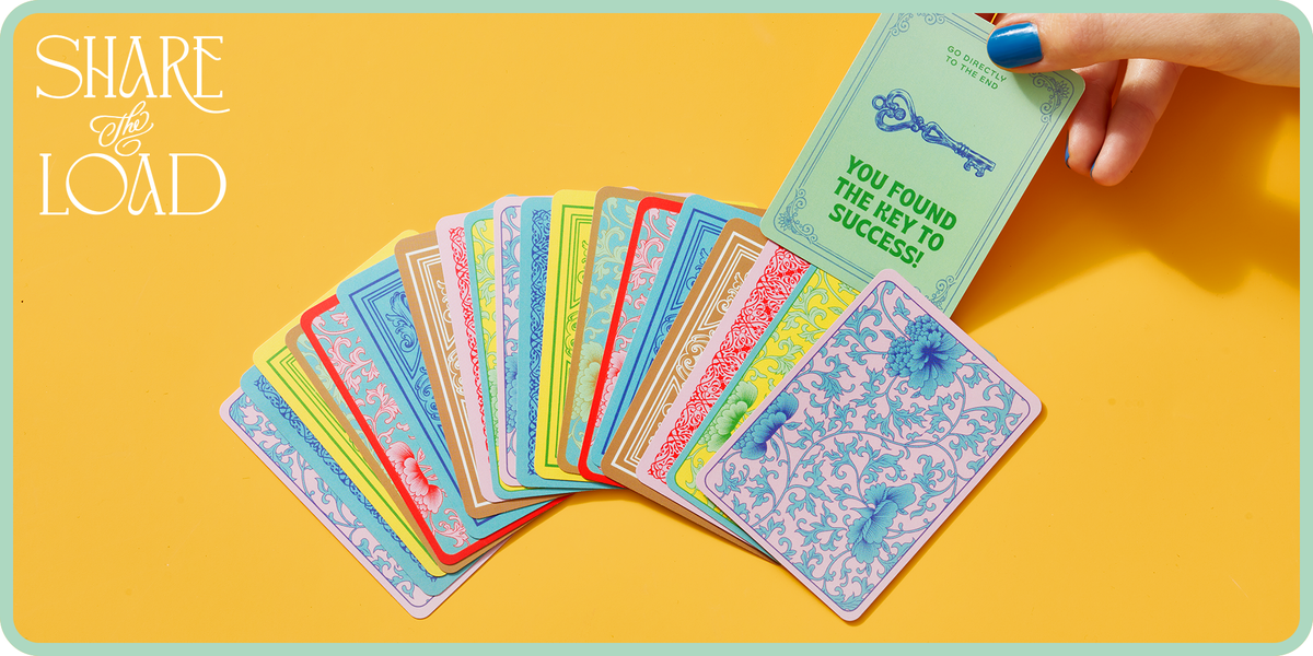 woman pulling 'key to success' card from a pile of game playing cards on yellow background