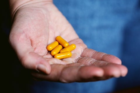 holding yellow pills