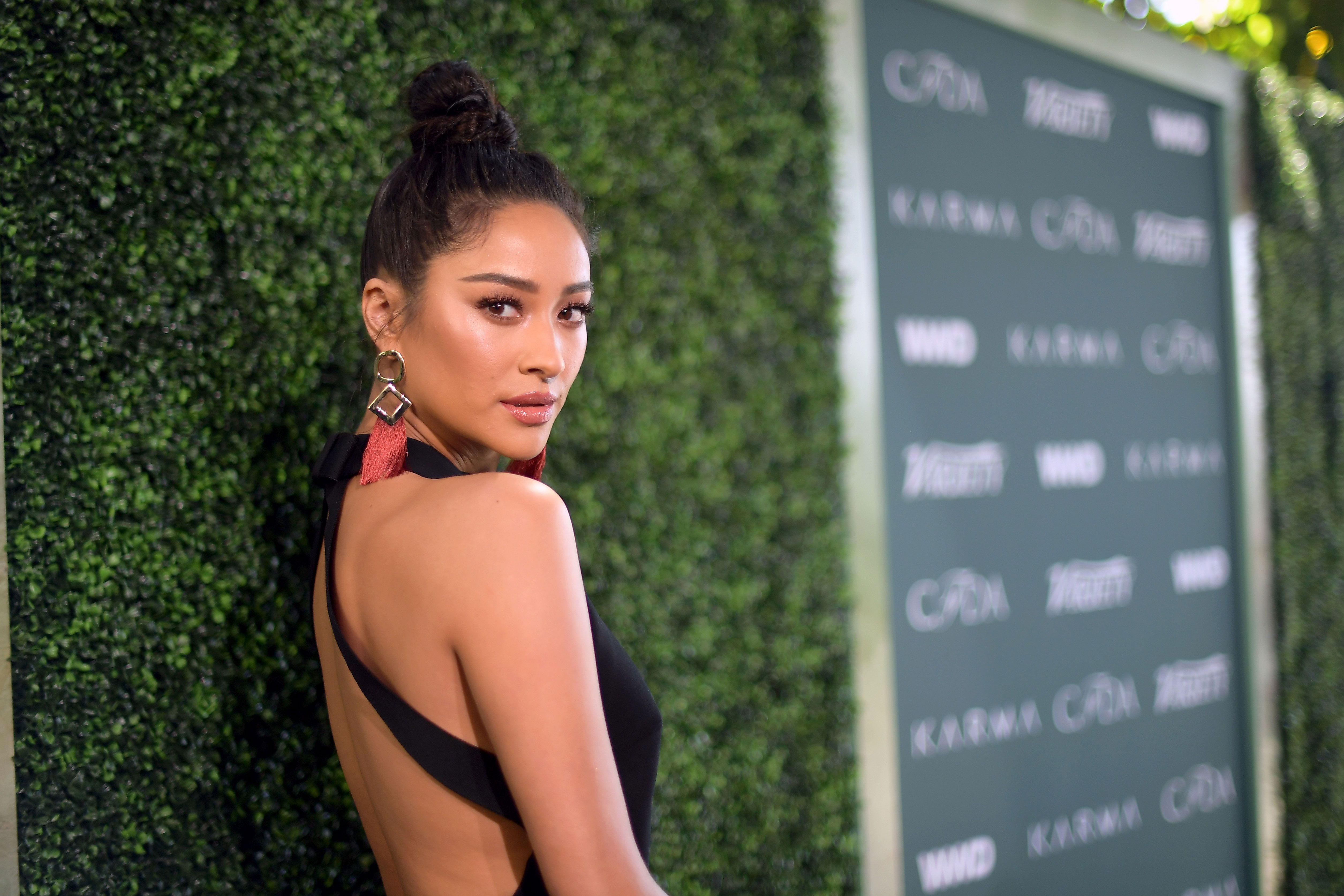 Shay Mitchell steps out of her hotel wearing an olive green Louis