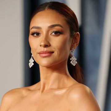 actress shay mitchell juicy with her hair up and dangly earrings