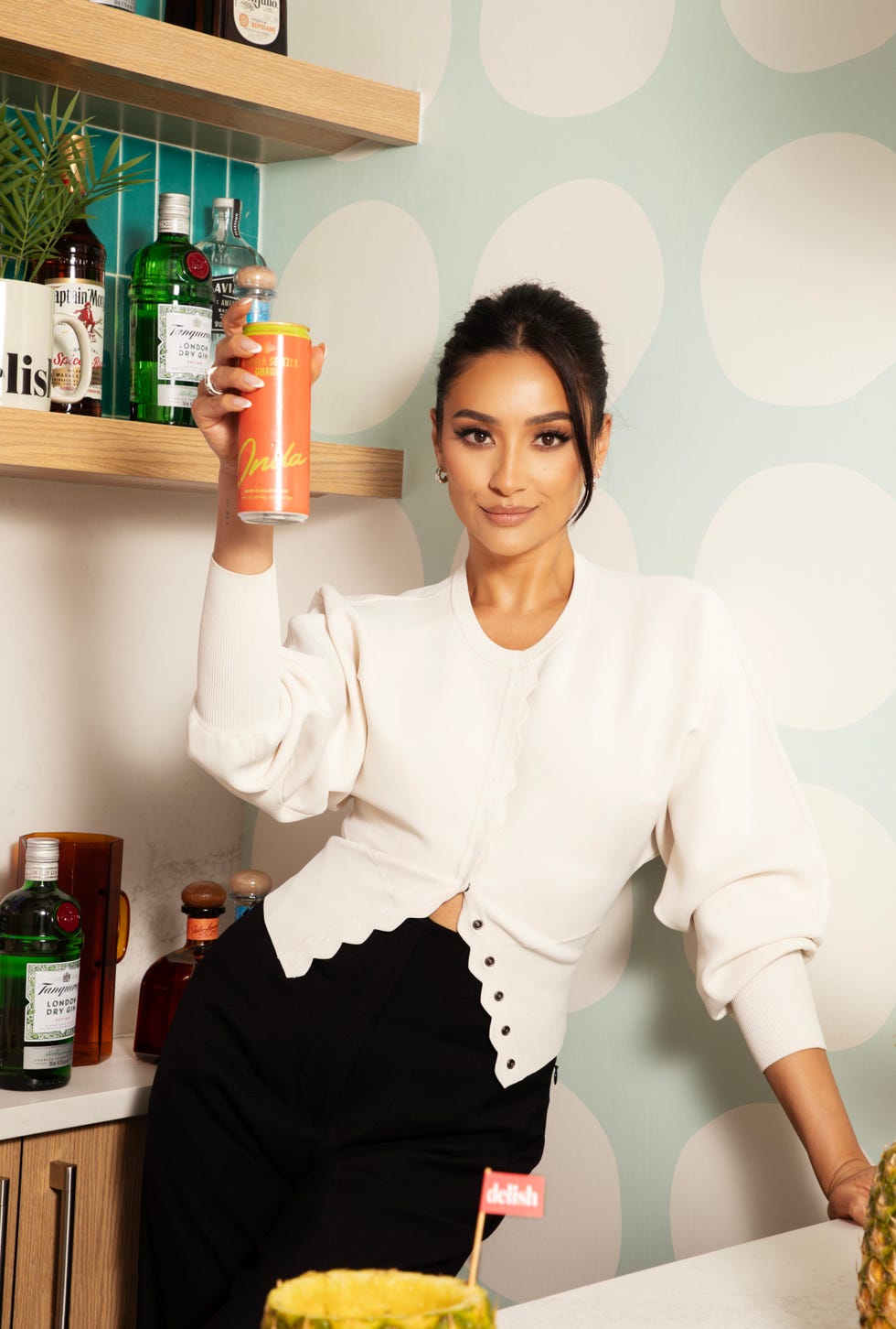 shay mitchell holding a drink