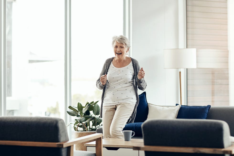 older woman dancing in her apartment