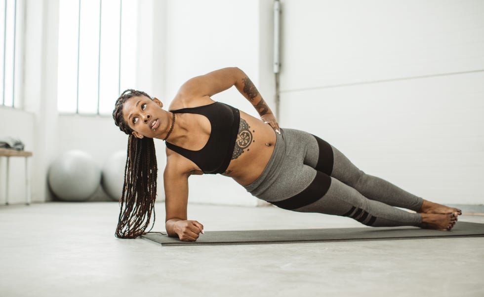 Young Sexy Slim Fitness Woman Doing Push-ups On Wall Background