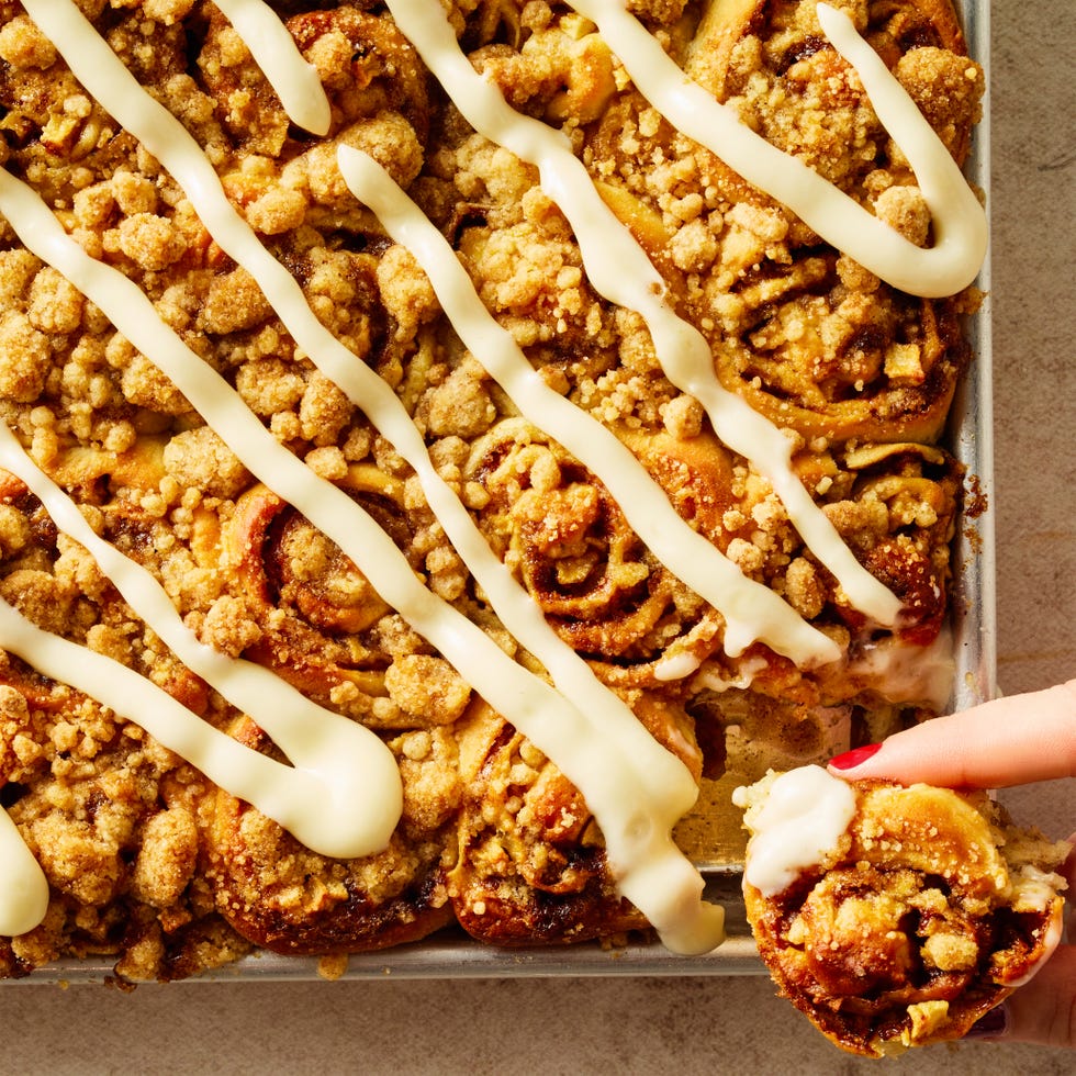 apple cinnamon roll bites on a sheet pan with icing