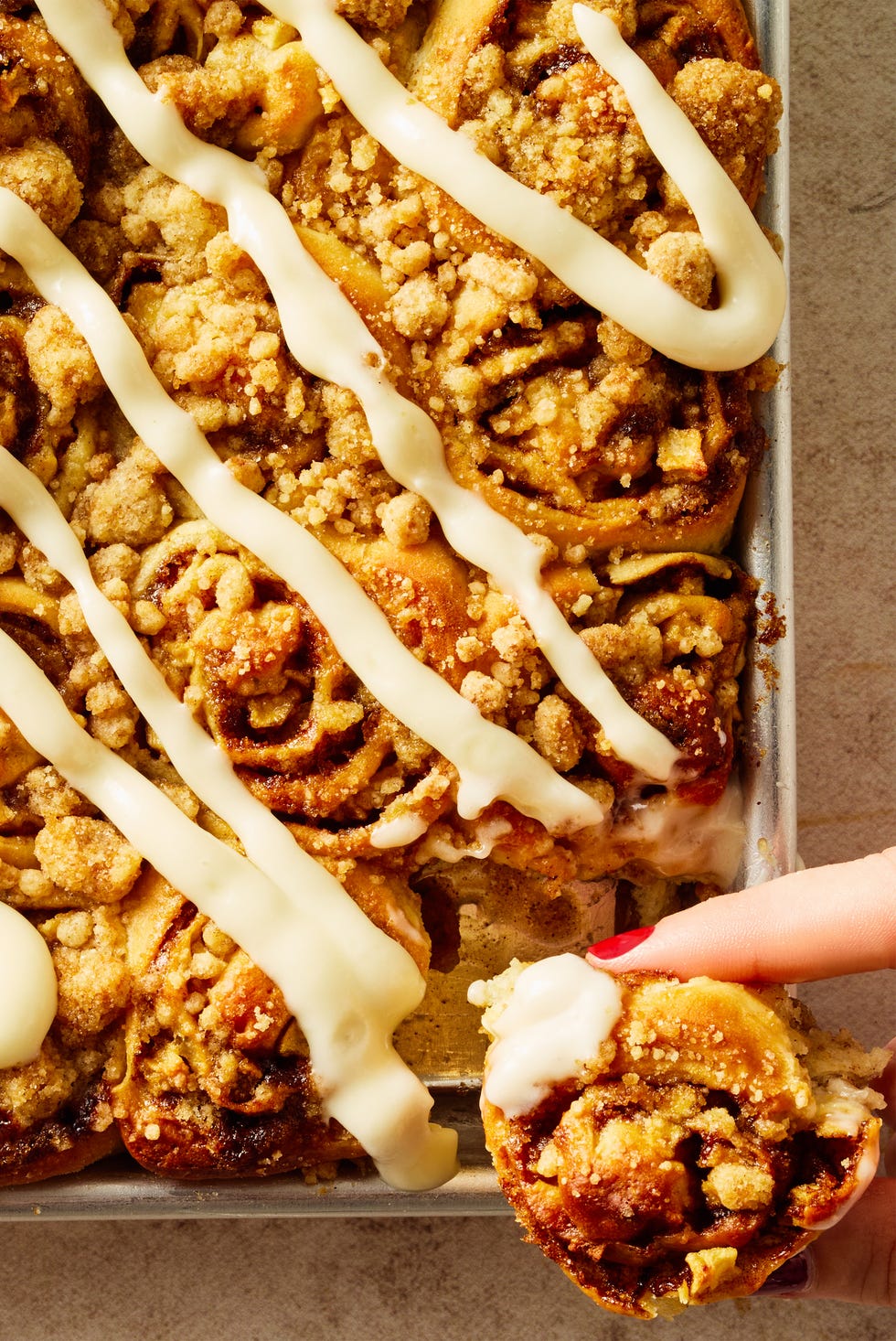 Sheet-Pan Apple Cinnamon Roll Bites apple cinnamon roll bites on a sheet pan with icing