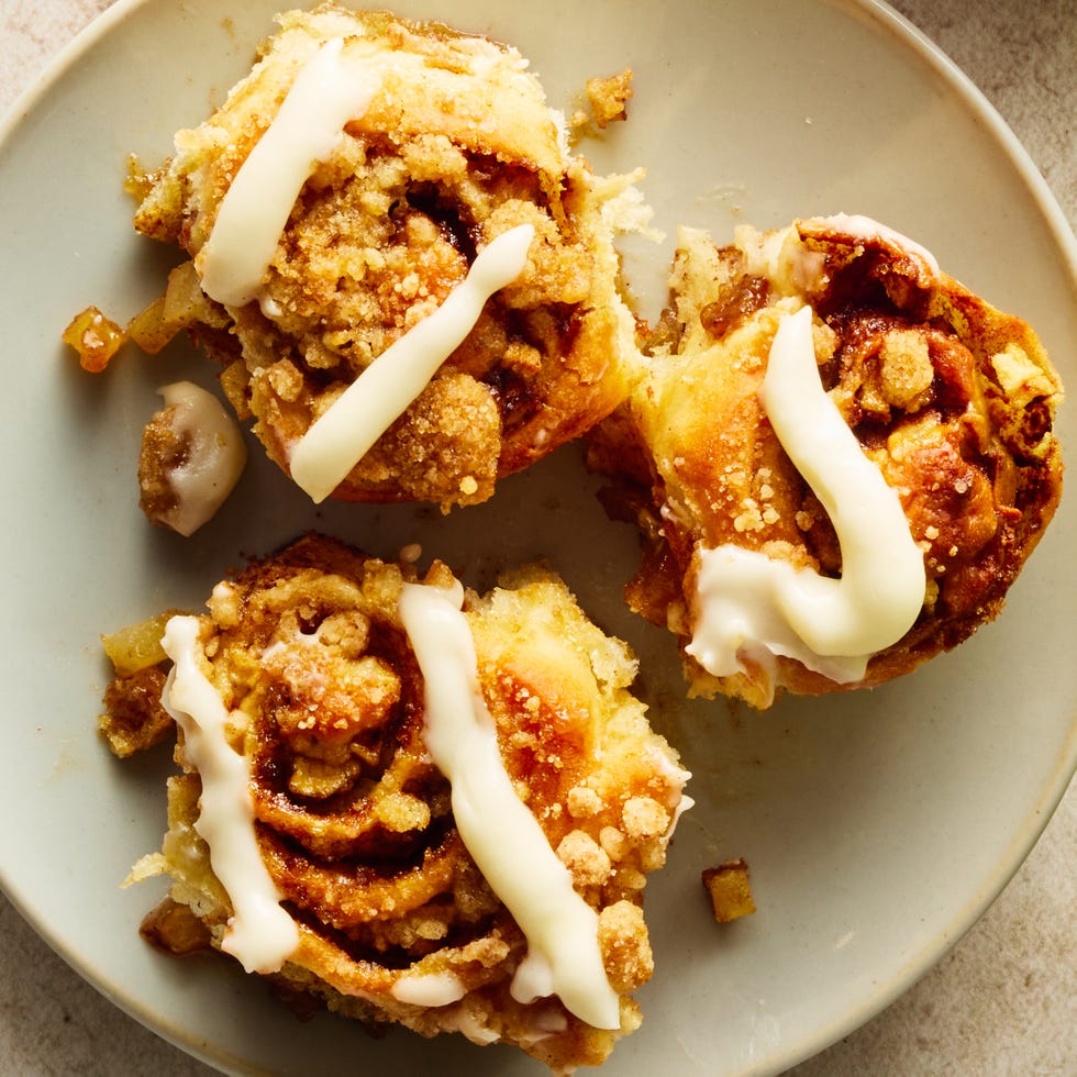 apple cinnamon roll bites on a sheet pan with icing