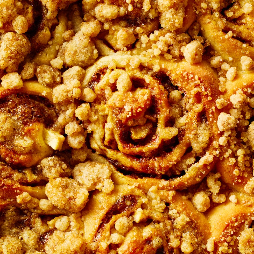 apple cinnamon roll bites on a sheet pan with icing