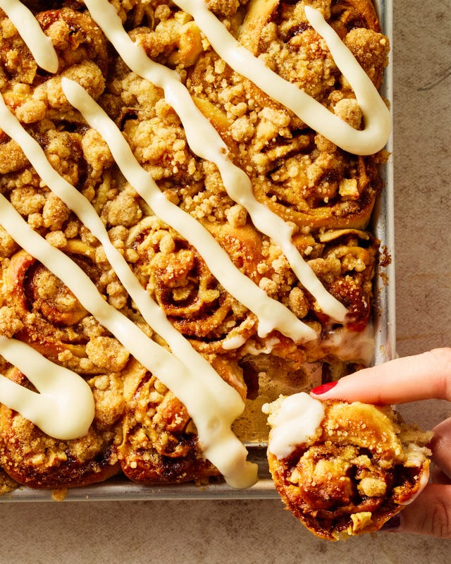 apple cinnamon roll bites on a sheet pan with icing