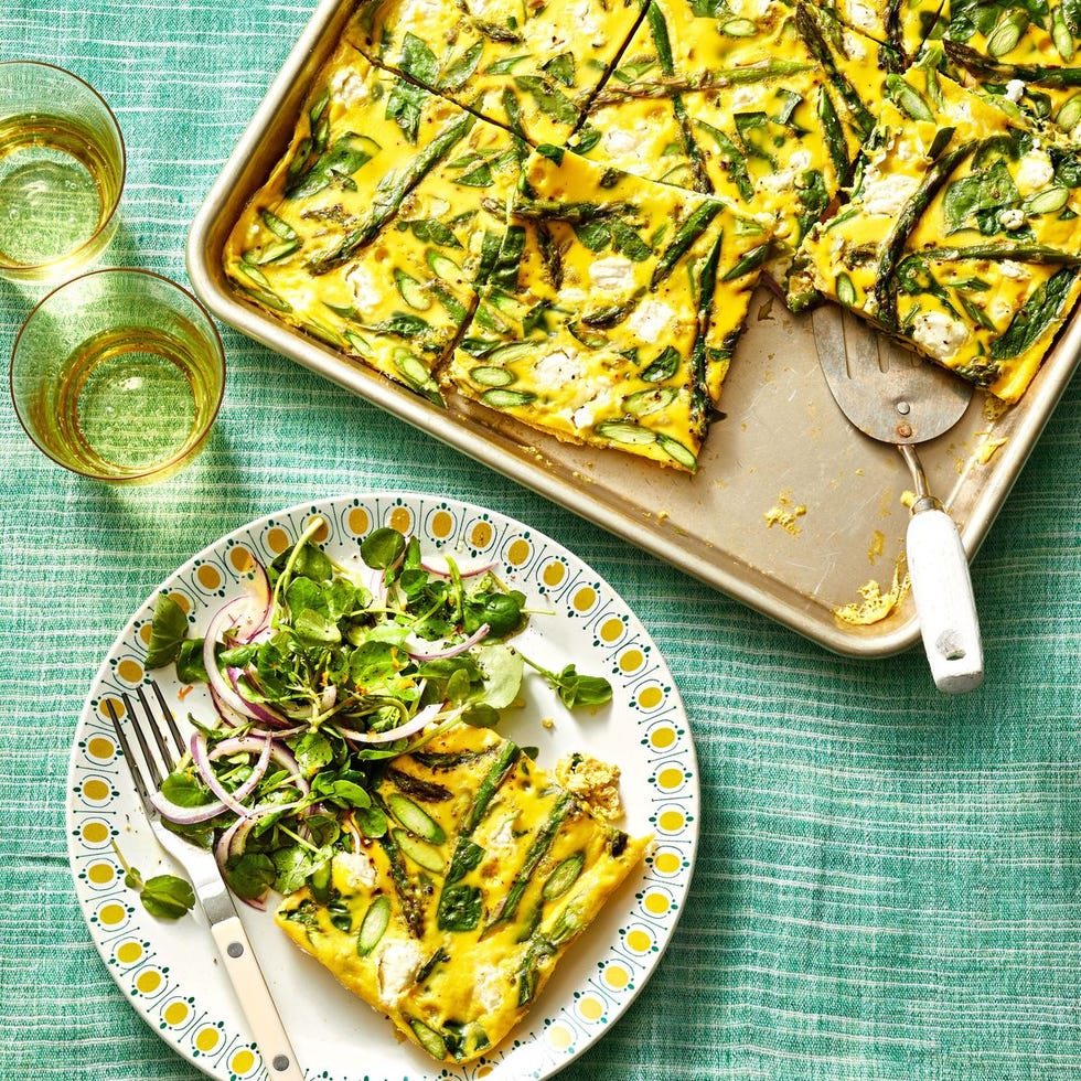 sheet pan asparagus frittata with a side salad on a plate