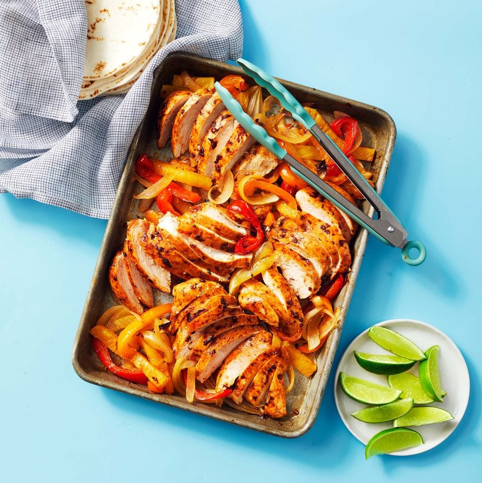 sheet pan chicken fajitas with a side of lime wedges