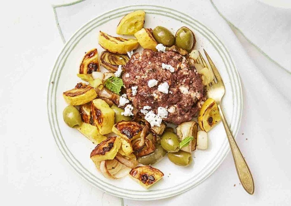meatloaf with green olives on a plate