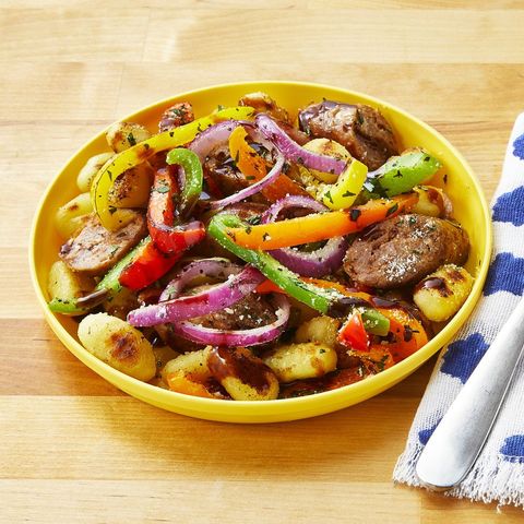 heet pan gnocchi with spicy sausage and peppers in yellow bowl