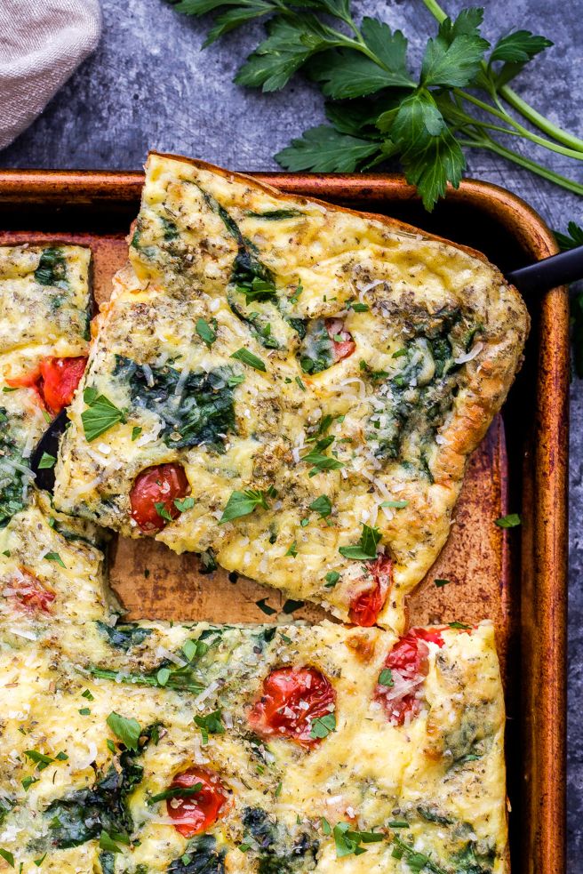 https://hips.hearstapps.com/hmg-prod/images/sheet-pan-dinners-spinach-tomato-frittata-1578083066.jpg?crop=0.9637254901960784xw:1xh;center,top&resize=980:*