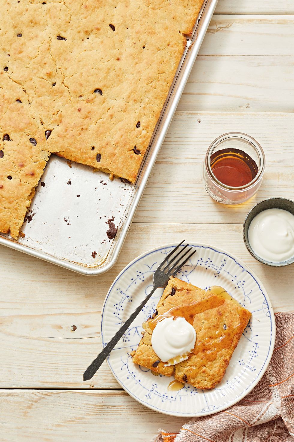 pb chocolate sheet pan pancake with a maple syrup and whipped cream
