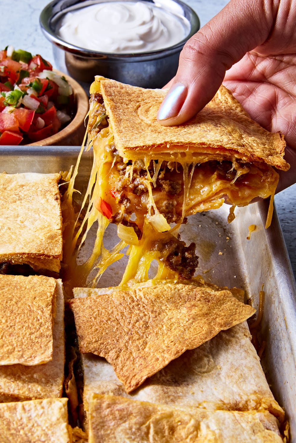 Sheet Pan Quesadillas tortillas filled with meat and cheese on a sheet pan