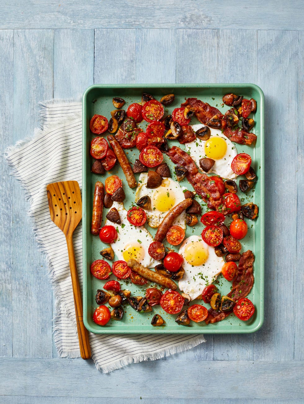 sheet pan sausage and tomatoes with fried eggs