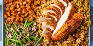 turkey, stuffing, sweet potatoes, and green beans on a sheet pan