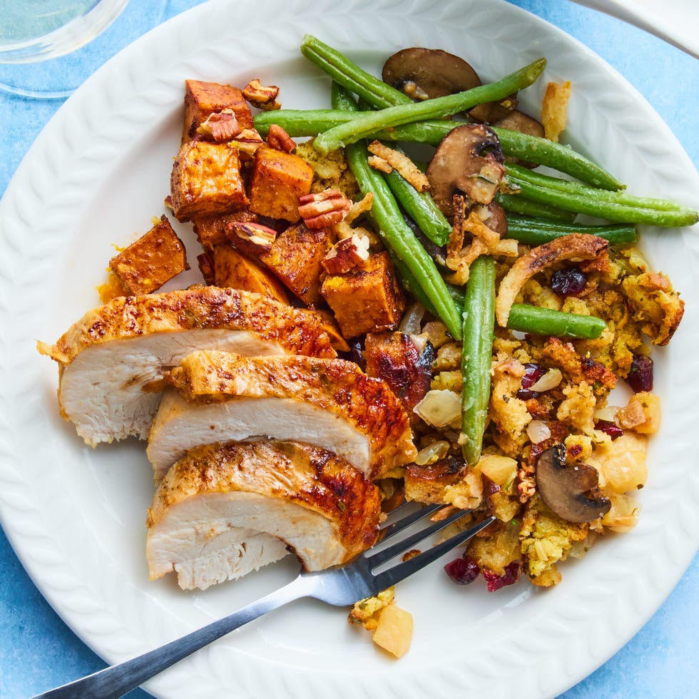 turkey, stuffing, sweet potatoes, and green beans on a sheet pan