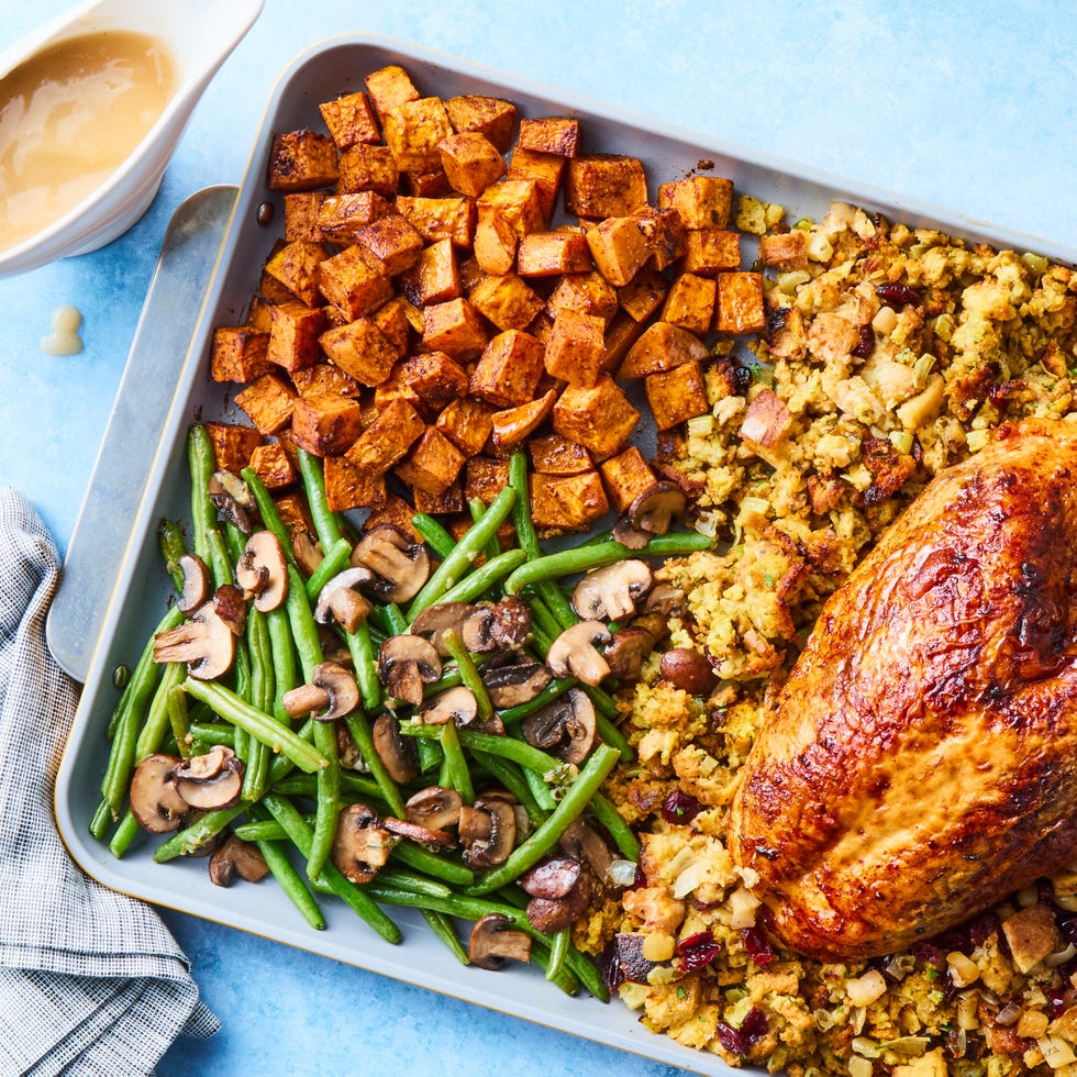 turkey, stuffing, sweet potatoes, and green beans on a sheet pan