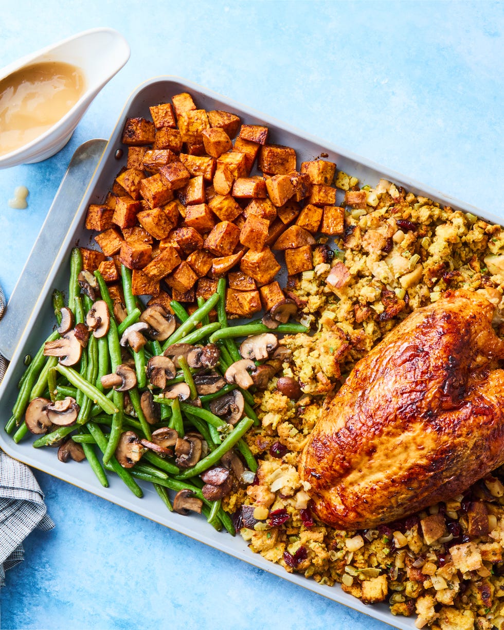turkey, stuffing, sweet potatoes, and green beans on a sheet pan