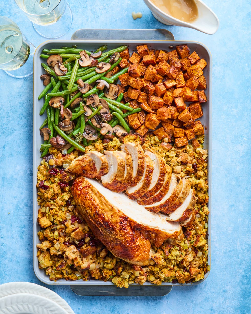turkey, stuffing, sweet potatoes, and green beans on a sheet pan