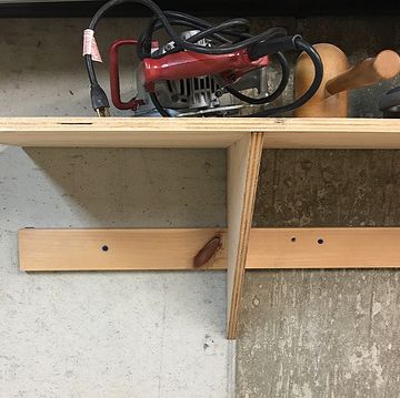a wooden shop shelf holding some equipment